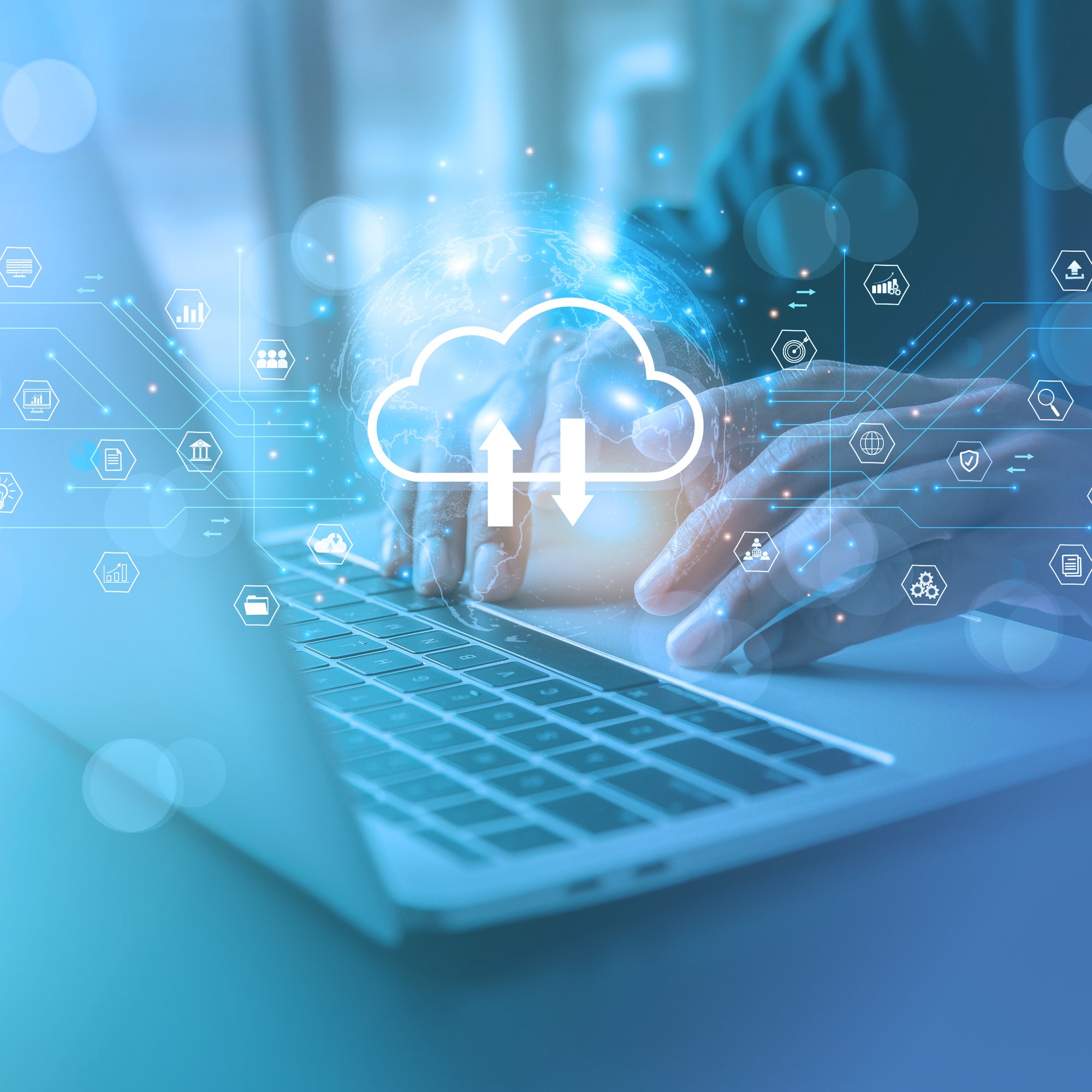 Laptop with blue overlay and hands typing on the keyboard. A white cloud icon floats above.