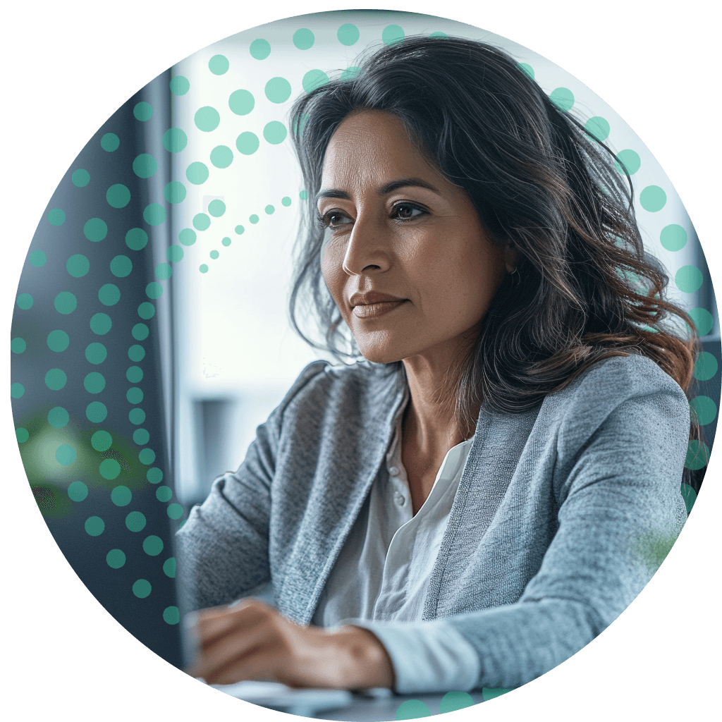 Business woman sitting at her desk, with green dots behind her.